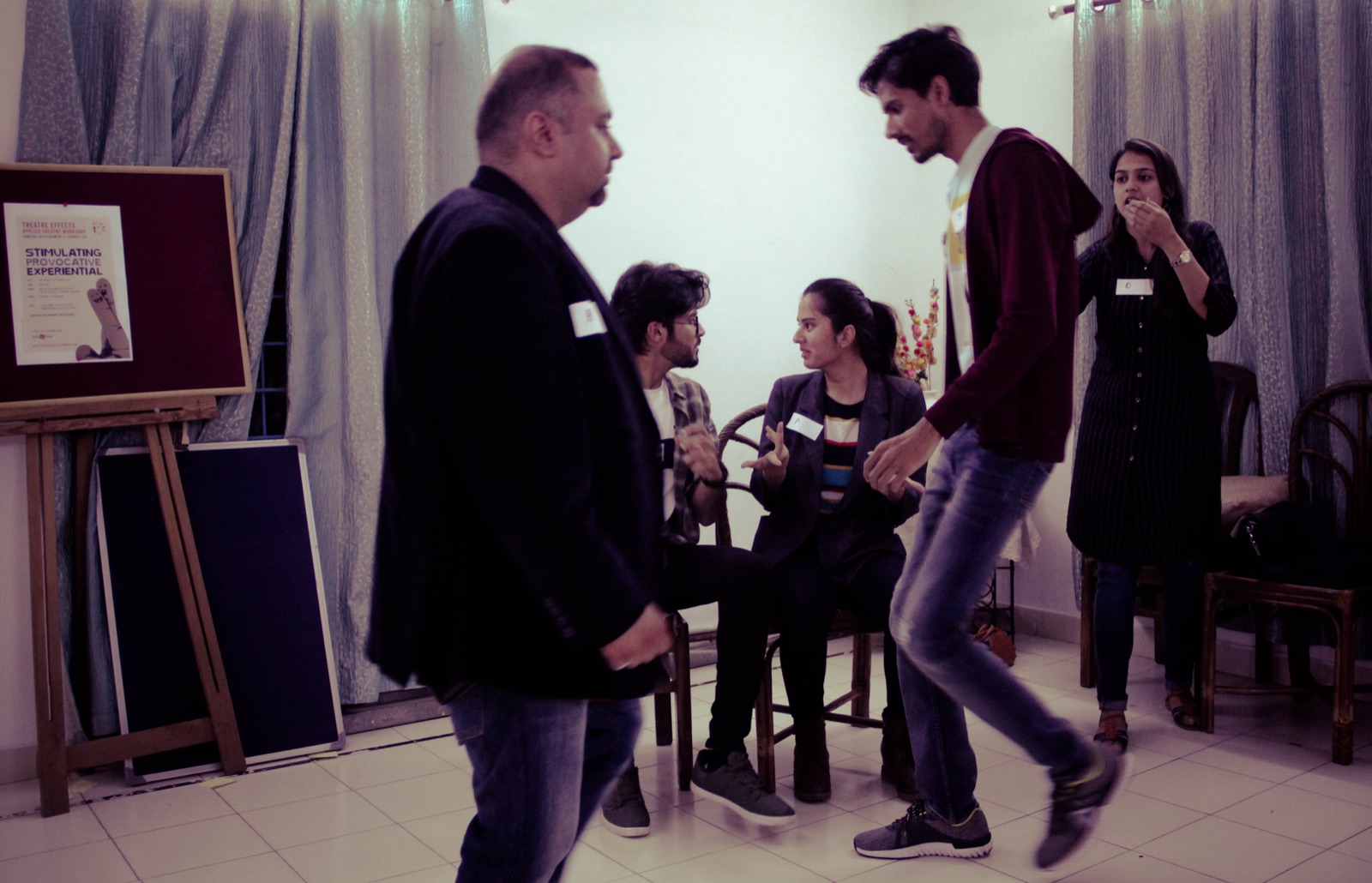 Two participants playing out a workplace moment while the group watches in a devised-scene exercise